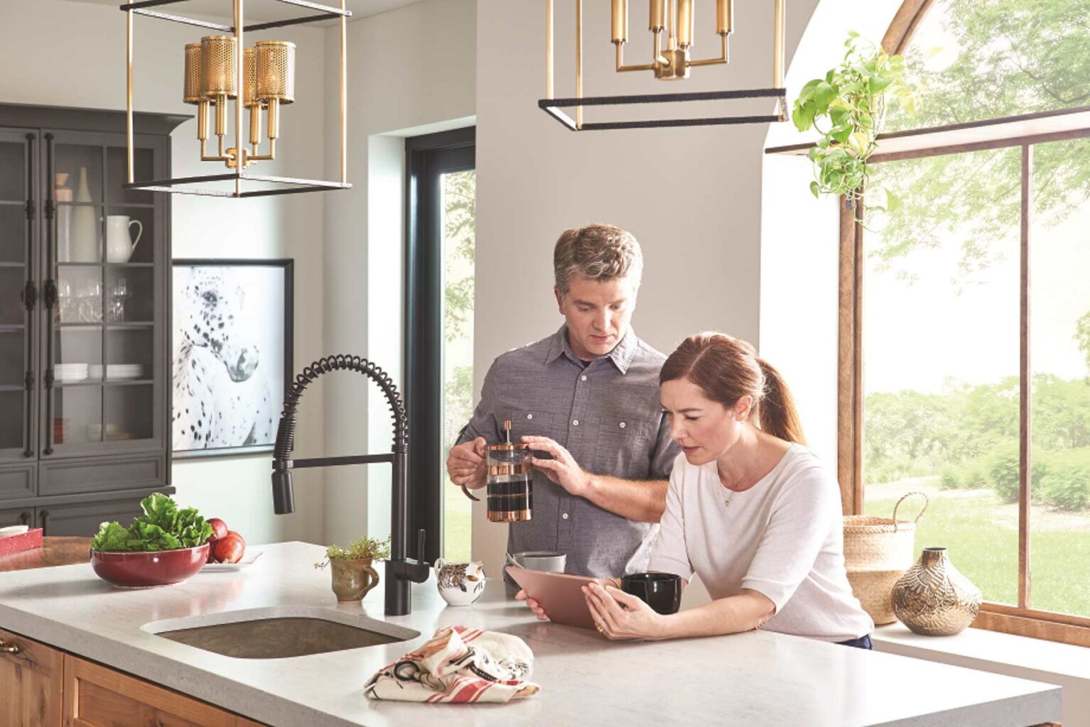 couple in kitchen looking at ipad together