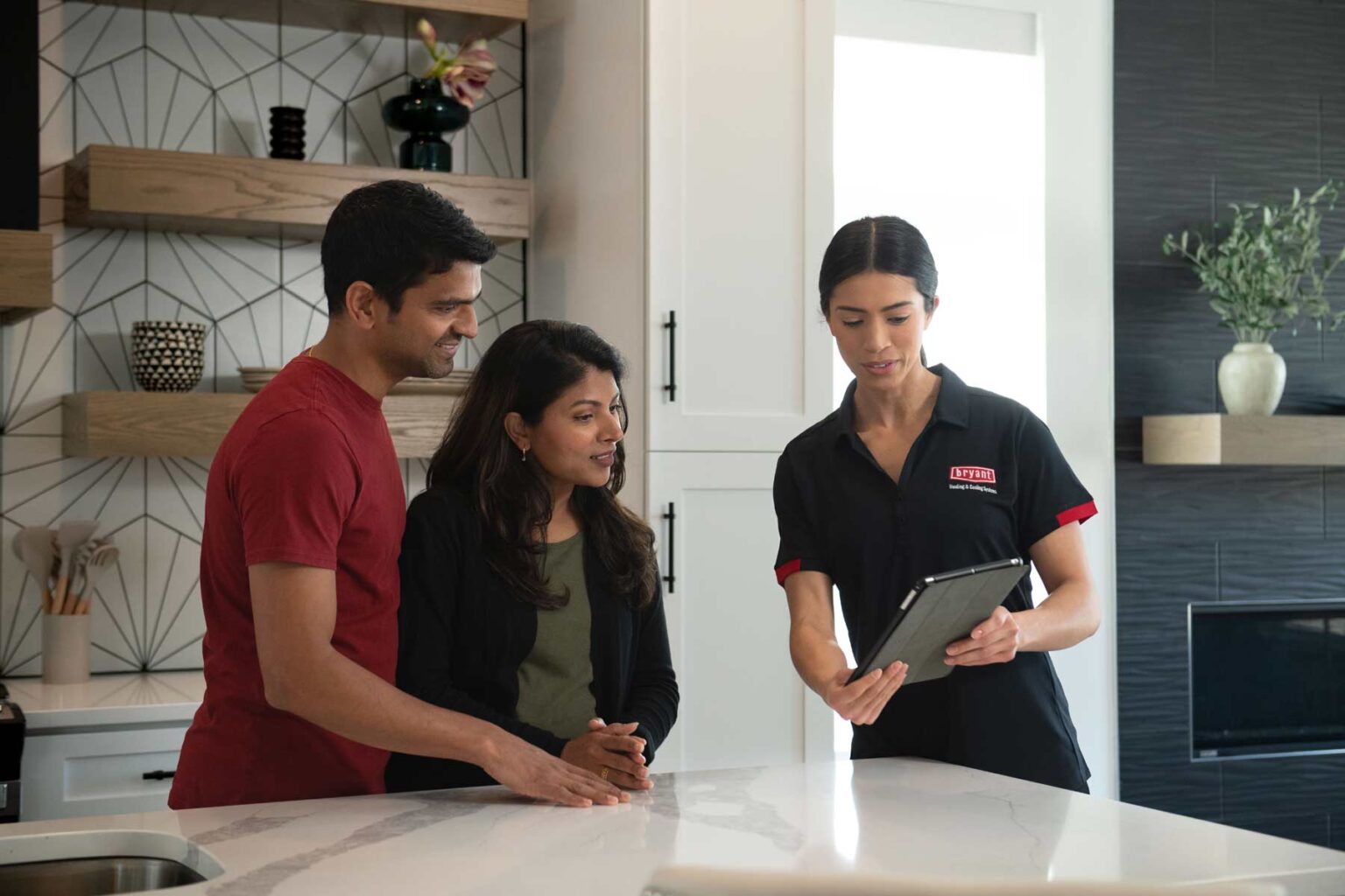 bryant dealer in home showing tablet to home owners